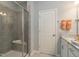 The bathroom features a glass-enclosed shower with a bench, granite countertop, and neutral tones at 2317 Bay Minette Station Sta # 545, Apex, NC 27502