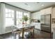 Dining area with modern chairs, hardwood floors, and large windows for natural light at 2317 Bay Minette Station Sta # 545, Apex, NC 27502