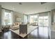 Bright living room featuring hardwood floors, large windows, stylish furnishings and a sliding door to the deck at 2317 Bay Minette Station Sta # 545, Apex, NC 27502