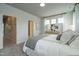 Inviting primary bedroom bathed in natural light, featuring a white brick accent wall, and ensuite access at 2317 Bay Minette Station Sta # 545, Apex, NC 27502