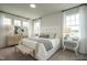 Bright, beautifully decorated primary bedroom featuring white brick accent wall and ample natural light at 2317 Bay Minette Station Sta # 545, Apex, NC 27502