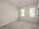 Bright bedroom featuring neutral carpet and two bright windows at 270 Purslane Dr, Franklinton, NC 27525