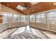 Sunroom with natural wood walls, tile flooring, ceiling fan, and skylights at 2921 Lawson Walk Way, Rolesville, NC 27571