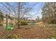 A picturesque backyard featuring a swing set, bridge over a pond, and lush, green foliage at 3104 Sandy Knoll Ln, Knightdale, NC 27545
