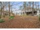 Large backyard featuring lush greenery, a classic swing set, and a view of the home's exterior at 3104 Sandy Knoll Ln, Knightdale, NC 27545