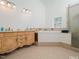 Bathroom features double sinks, soaking tub, and walk-in shower at 3104 Sandy Knoll Ln, Knightdale, NC 27545