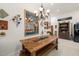 Dining room featuring a rustic wooden table, bench seating and an ornate chandelier at 3104 Sandy Knoll Ln, Knightdale, NC 27545