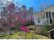 Exterior shot of a cottage with a flowering tree, showcasing a serene and picturesque outdoor setting at 3104 Sandy Knoll Ln, Knightdale, NC 27545