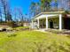 Inviting front yard with a well-manicured lawn and a charming covered porch with stone columns at 3104 Sandy Knoll Ln, Knightdale, NC 27545