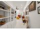 Hallway with built-in shelving leads to a cozy living area with yellow armchair at 3104 Sandy Knoll Ln, Knightdale, NC 27545