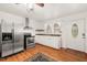 Well-lit kitchen with stainless steel appliances, custom countertops, and convenient exterior access at 3104 Sandy Knoll Ln, Knightdale, NC 27545