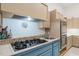 Kitchen boasts a gas stovetop, stainless steel oven, and neutral countertops with tiled backsplash at 3104 Sandy Knoll Ln, Knightdale, NC 27545