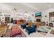 Open floor plan of a bright living room with fireplace and view into a modern kitchen at 3104 Sandy Knoll Ln, Knightdale, NC 27545