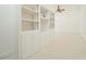 Bright, open living room with built-in shelving, cabinets, and a ceiling fan at 3104 Sandy Knoll Ln, Knightdale, NC 27545