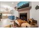 Living room with a stone fireplace and hearth with a large flat screen TV at 3104 Sandy Knoll Ln, Knightdale, NC 27545