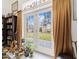 Bright living room featuring a patio access, filled with sunlight and plants at 3104 Sandy Knoll Ln, Knightdale, NC 27545