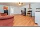 Open living area featuring wood floors, an adjacent kitchen, and a cozy seating arrangement at 3104 Sandy Knoll Ln, Knightdale, NC 27545