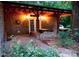 Charming outdoor dining area features stone accents and cozy lighting for memorable gatherings at 3104 Sandy Knoll Ln, Knightdale, NC 27545