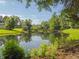 Pond view with a bridge, gazebo, and surrounding foliage at 3104 Sandy Knoll Ln, Knightdale, NC 27545