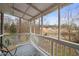 Cozy screened porch overlooking nature and a pond, ideal for relaxation and enjoying the outdoors at 3104 Sandy Knoll Ln, Knightdale, NC 27545