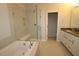 Luxurious bathroom featuring a soaking tub, glass-enclosed shower, and double sink vanity with quartz countertop at 3195 Mission Olive Pl # 352, New Hill, NC 27562