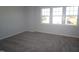 Bright bedroom with plush carpet, a large window offering natural light and neighborhood views at 3195 Mission Olive Pl # 352, New Hill, NC 27562