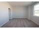 Spacious bedroom with plush carpet, a large window offering natural light and tree-lined views at 3195 Mission Olive Pl # 352, New Hill, NC 27562