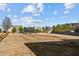 This home has a large backyard with mature trees, a trampoline, and a wooden fence at 35 Henry Rifle Ln, Angier, NC 27501