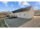 Backyard view showcasing an expansive lot with gravel area and a deck, offering a private outdoor space at 35 Henry Rifle Ln, Angier, NC 27501