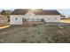View of the backyard of this home with a large deck and a retaining wall at 35 Henry Rifle Ln, Angier, NC 27501