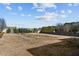 Expansive backyard with a trampoline, surrounded by lush greenery and a wooden fence at 35 Henry Rifle Ln, Angier, NC 27501