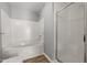 Bathroom featuring tiled tub, shower with a clear glass door, toilet and vinyl flooring at 35 Henry Rifle Ln, Angier, NC 27501