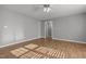 Sunlit bedroom featuring neutral walls, hardwood floors and a modern ceiling fan with lights at 35 Henry Rifle Ln, Angier, NC 27501