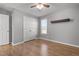 Neutral bedroom with hardwood floors, ceiling fan, large closet, and bright natural light at 35 Henry Rifle Ln, Angier, NC 27501