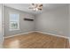 Sunlit bedroom with hardwood floors and neutral walls with a window letting in natural light at 35 Henry Rifle Ln, Angier, NC 27501