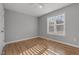 Bedroom features light hardwood floors, fresh paint and a large window with blinds at 35 Henry Rifle Ln, Angier, NC 27501