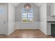 Bright dining room with wainscoting, wood-look floors, and a modern pendant light fixture at 35 Henry Rifle Ln, Angier, NC 27501