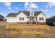 Charming one-story home with a manicured lawn and inviting front porch at 35 Henry Rifle Ln, Angier, NC 27501