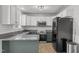 Modern kitchen featuring granite countertops, stainless steel appliances, neutral backsplash, and ample counter space at 35 Henry Rifle Ln, Angier, NC 27501
