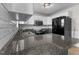 Updated kitchen showcasing granite countertops, stainless steel appliances, and subway tile backsplash at 35 Henry Rifle Ln, Angier, NC 27501