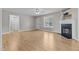 Comfortable living room featuring a fireplace, ceiling fan, and wood-look flooring at 35 Henry Rifle Ln, Angier, NC 27501