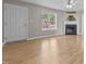 Bright living room featuring a fireplace and neutral walls, illuminated by a ceiling fan with light fixture at 35 Henry Rifle Ln, Angier, NC 27501