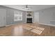 Inviting living room featuring a fireplace and neutral walls, enhanced by wood-look floors and a ceiling fan at 35 Henry Rifle Ln, Angier, NC 27501