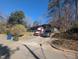 A driveway with parked vehicles leads to a home, with greenery and trees surrounding it at 3501 Turnbridge Dr, Raleigh, NC 27609