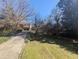 Charming home featuring a long driveway and a well-manicured front yard with mature trees and landscaping at 3501 Turnbridge Dr, Raleigh, NC 27609