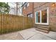 Brick house exterior with a wooden fence and a sliding glass door at 3716 Yorktown Pl, Raleigh, NC 27609