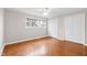 Bright bedroom with parquet floors, a window, a ceiling fan, and double closets at 3716 Yorktown Pl, Raleigh, NC 27609