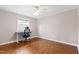 Bedroom with parquet floors, ceiling fan, and a window, furnished with a desk and chair at 3716 Yorktown Pl, Raleigh, NC 27609