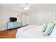 Comfortable bedroom with a light blue dresser, ceiling fan, and ample natural light from the window at 3716 Yorktown Pl, Raleigh, NC 27609