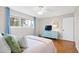 Bright bedroom with a ceiling fan, dresser, and a large window offering plenty of natural light at 3716 Yorktown Pl, Raleigh, NC 27609